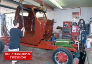 Painted cab being lowered on the chassis  <div class="download-image"><a href="https://oldinternationaltrucks.com/wp-content/uploads/2017/09/51.jpg" download><i class="fa fa-download"></i> <span class="full-size"></span></a></div>